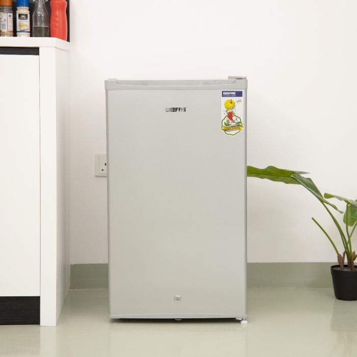 Geepas Single Door Refrigerator (GRF119SPE) with tempered glass shelves, low noise, energy saving, and tropical climate performance. Perfect for home or office use