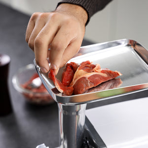 Geepas GMG746 Meat Grinder online. 800W power, stainless steel blades, reverse function, 3 cutting plates, sausage & kubbe attachments. Grind 1kg/min. 2-year warranty